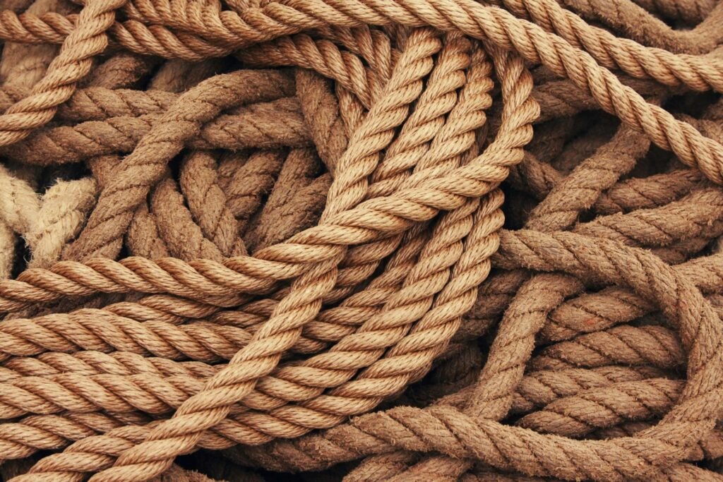 Detailed close-up view of intertwined brown ropes used as ship accessories.